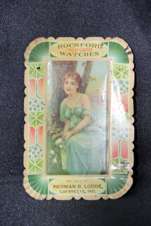 Early Advertising Tip Tray - Rockford Watch Company: 10-3586 Early vintage advertising tip tray for Rockford Watch Company. Printed on the tray - "For Sale by Herman B. Lode, Lafayette, Ind.". Made by H.D. Beach Co. Shows light wear. Measures 5 x 3 1/4 