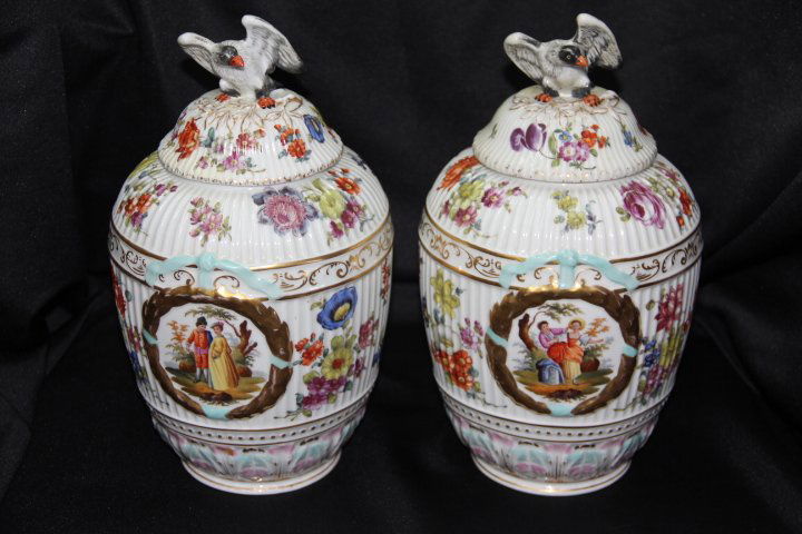 Pair of Porcelain Lidded Containers: 56-1365-1366 Pair of porcelain lidded containers with outdoor figural scenes. Lids have an eagle on top. 12 1/2 in. tall each. Mark on bottom is not clear.