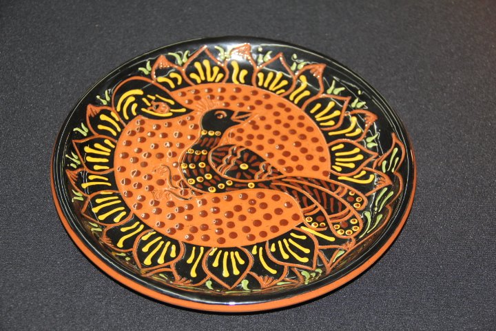 Redware Nolde Forest Plate: 183-1731 Redware Nolde Forest plate. Measures 10 3/4 in. diameter. Heavily decorated, "Village of Angelica", #3 of this design, signed.