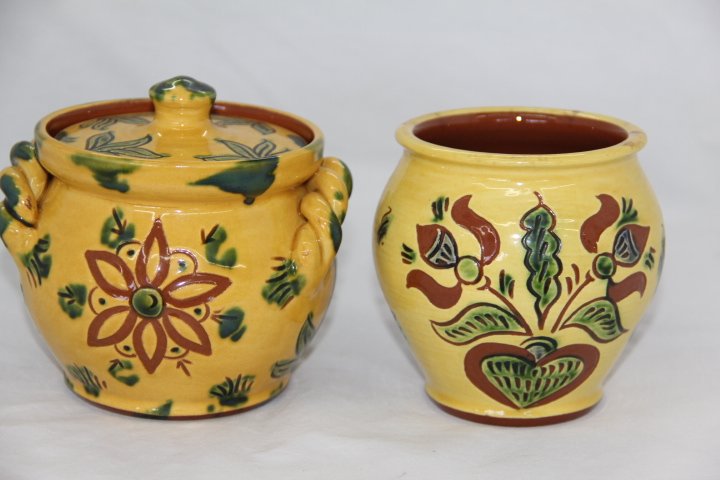 Redware Pottery Jars: 185-703-4 Redware covered jar. Yellow glaze with braided handle, by Breininger Pottery, 2003, "Sonne". Second jar is uncovered, yellow glase, 2003 signed Nolde Forest "Clooudy Day" both measuring 4 3/