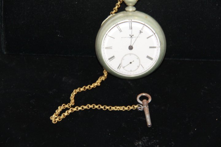 Antique Elgin Key Wind Pocket Watch: 173-4422 1900's Elgin pocket watch, nickel silver, key wind, with chain, no key. Engraved "G.M. Wheeler". Measures 2.25" diam. Inside case stamped "Fahys Oresilver No.1 Pat. April 22 1879, 212234".