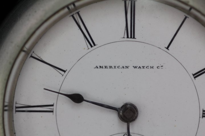 Antique American Watch Co. Key Wind Pocket Watch: 184-4433 1889 American Watch Co. Bartlett, Waltham Mass. Key wind, nickel silver, no key or no chain. Watch #699683. Measures 2.25" diam. Case has scratches.