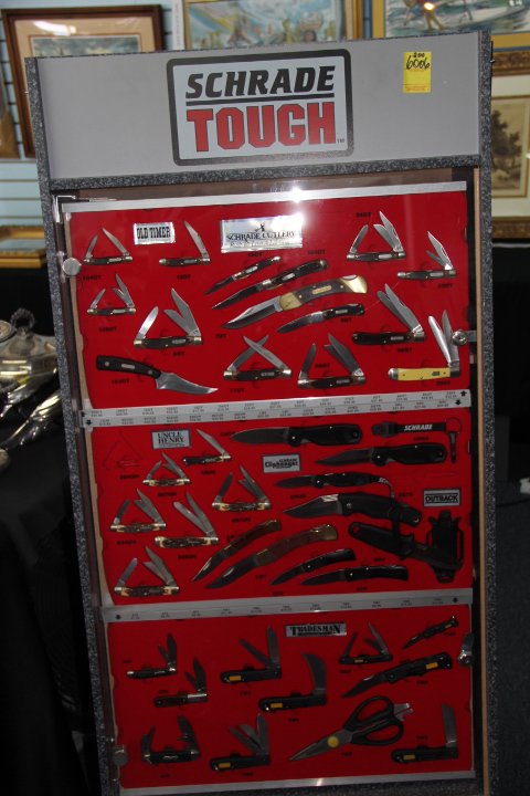 Schrade Cutlery Assorted Knives and Display Case, 1969: 200-6006 Assorted Schrade cutlery in display case, 13 Old Timer, 6 Uncle Henry, 4 Cliffhanger, 2 Lockblade, 5 misc. 10 Tradesman, 1 Tradesman shear. Rolling case measures 56x24x14.