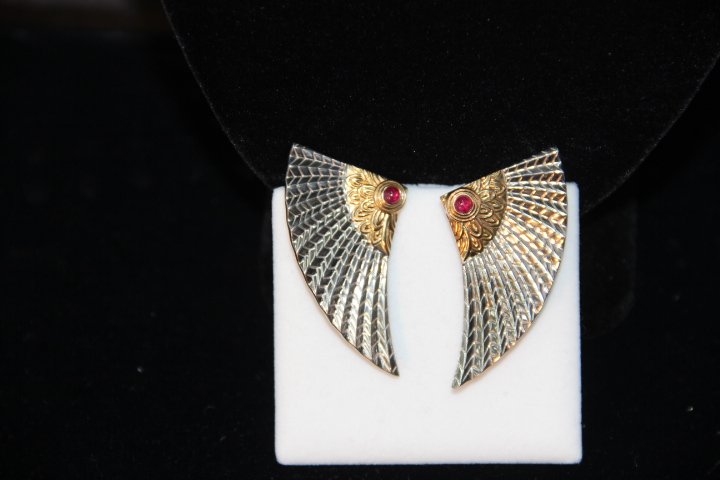 ErtÃ© "The Nile" Earrings: 223-4459 ErtÃ© earrings of gold, silver, bezel set Ruby cabochon.CFA 14K S/S "The Nile" design is Egyptian themed. 14K, S/S, Signed. (information by Erte, Art to Wear, the Complete Jewelry Book).