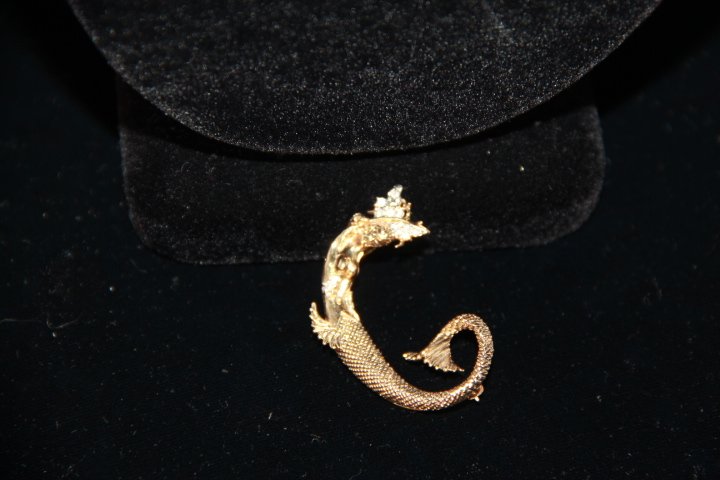 ErtÃ© "Mermaid" "C" Brooch: 227-4463 Mermaid "C" ErtÃ© brooch. of gold, & diamonds. 1.75". No Chain. "The Alphabet" is one of the best-known and most sought-after works by ErtÃ© . (information by Erte Art to Wear the Complet