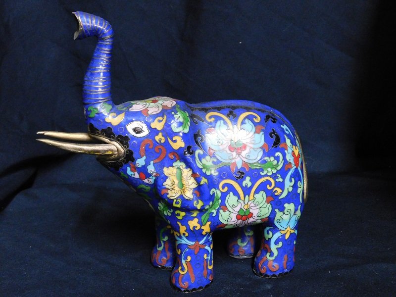 Cloisonne Elephant: Blue cloisonne elephant. Multi colored floral design. Measures 8 1/2 in. tall x 7 in. long.