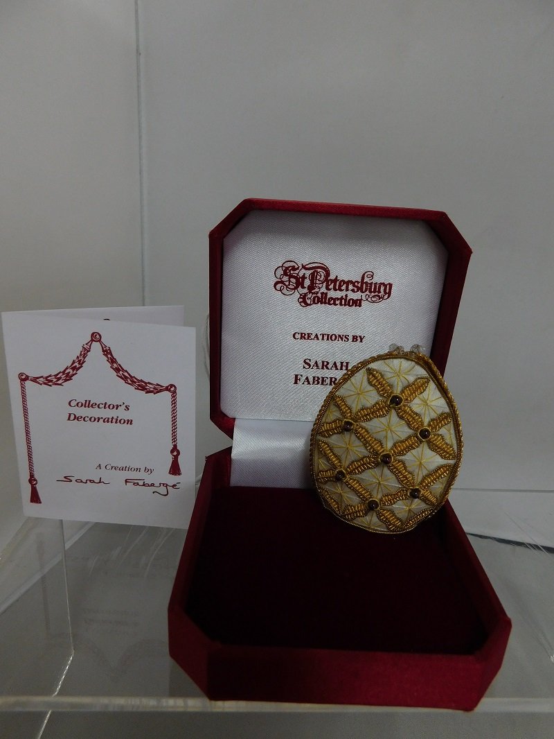 Sarah Faberge Collector's Decoration 2005: 2005 St. Petersburg Collection created by Sarah Faberge. Decoration in shape of egg in woven and hand-sewn sill, adorned with natural precious stones. Measures 3" high, 2" wide, 1.75" deep. Signed on 