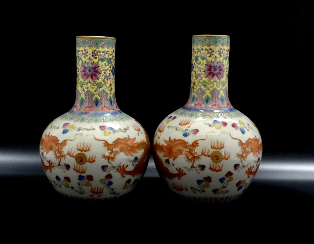 Pair of Chinese Famille Rose Vases: Famille Rose dragon vases, decorated with red dragons chasing through clouds and a green floral border, six characters mark on bottom. H 9” W 6"