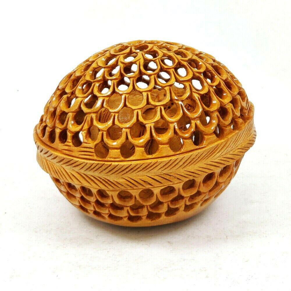 Hand Carved Undercut Egg Elephant Inside Wooden: Product Description : Item : Hand Carved Undercut Egg Elephant Inside Decorative Showpiece Material : Kadam Wood Length : 3.5 Inches Width : 3 Inches Height : 2.5 Inches Item Weight : 35 Grams Shippin