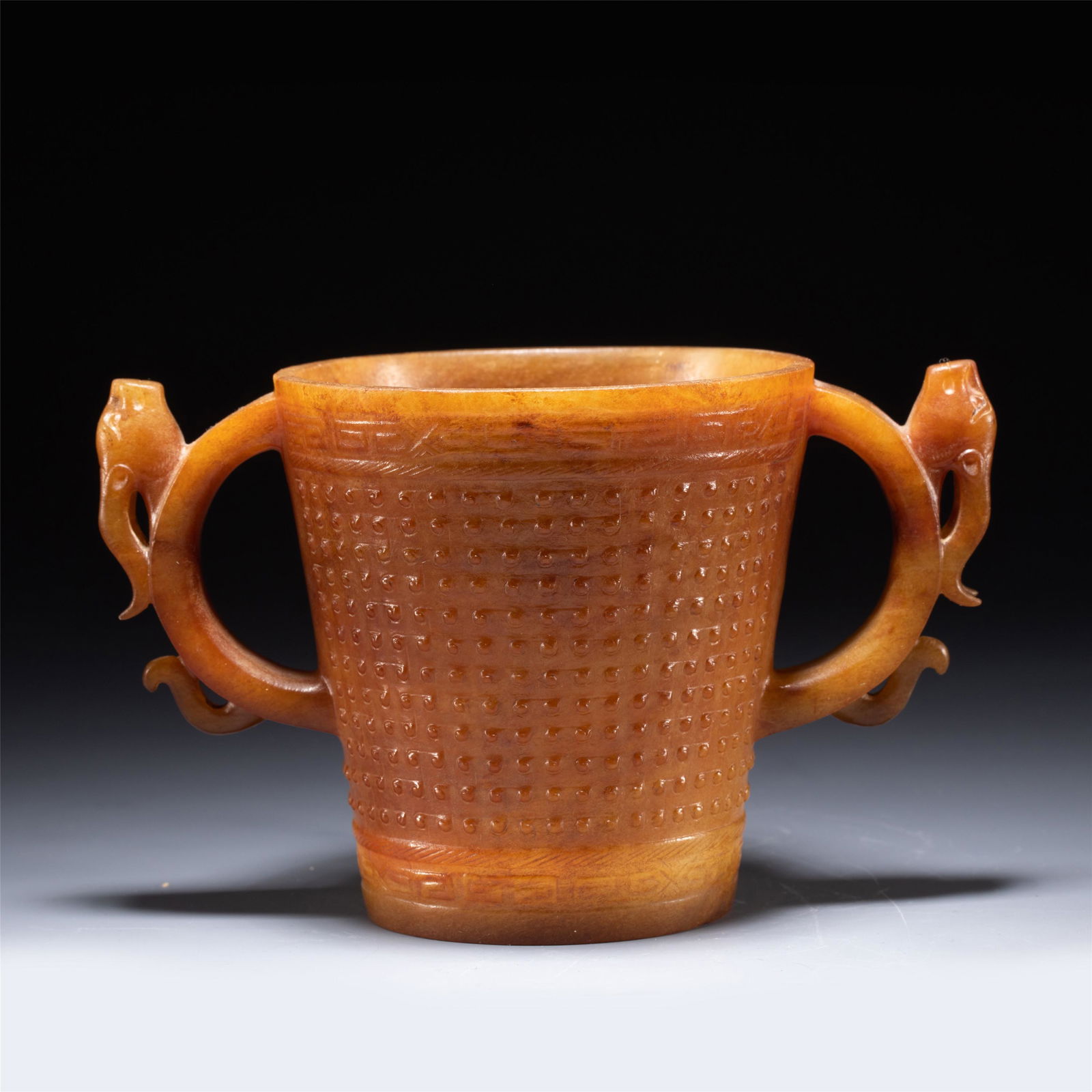 A CHINESE CARVED JADE CUP WITH DOUBLE HANDLES (1 of 7)