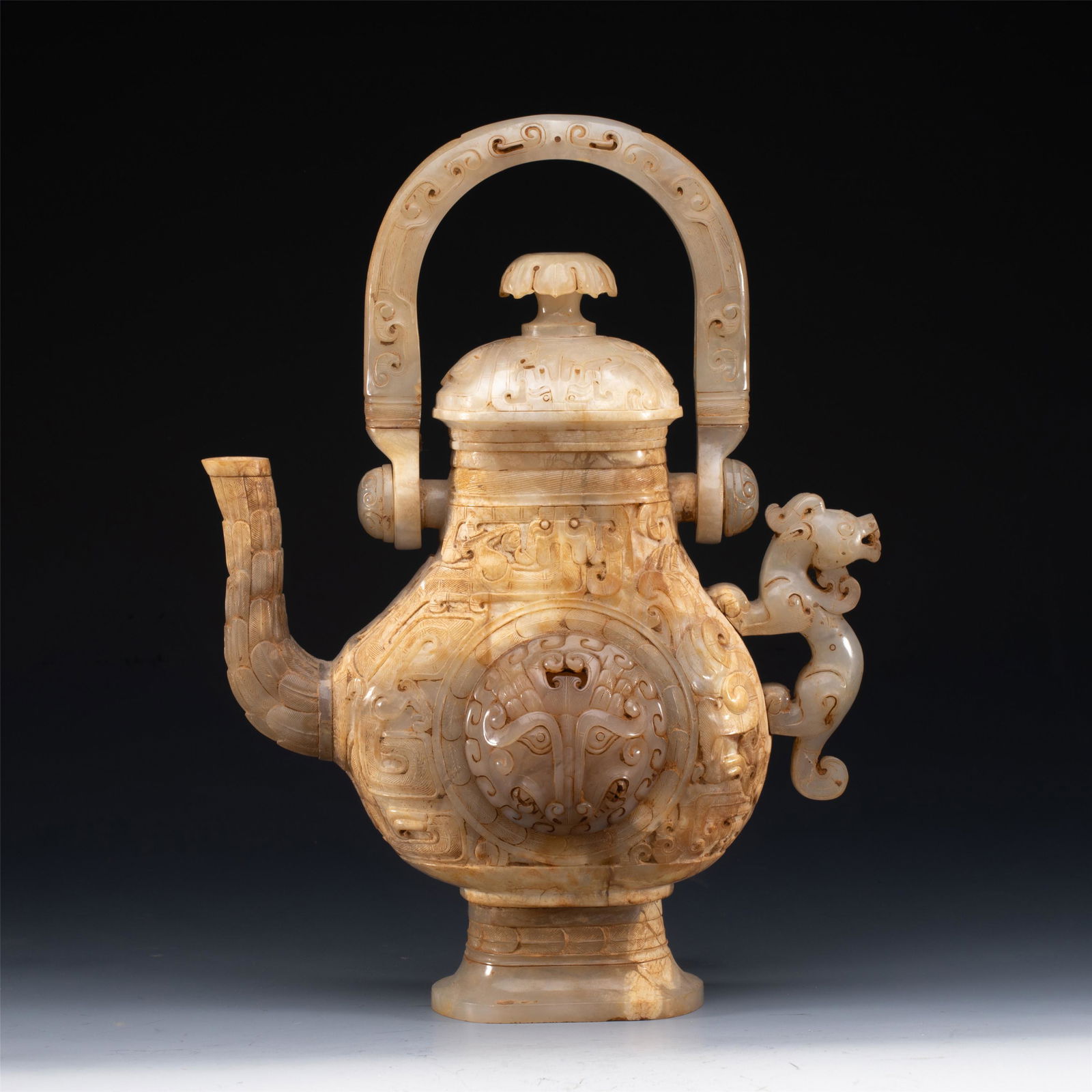 A CHINESE ARCHAIC CARVED JADE POT WITH LOOP HANDLE (1 of 10)