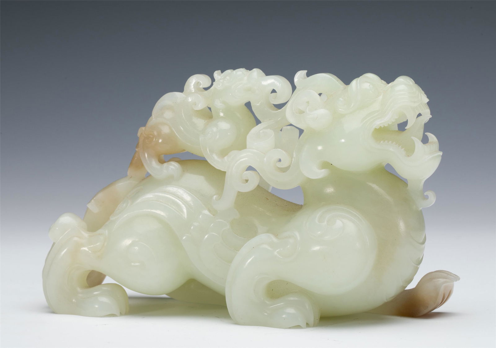 A CHINESE CARVED JADE MYTHICAL BEAST (1 of 8)