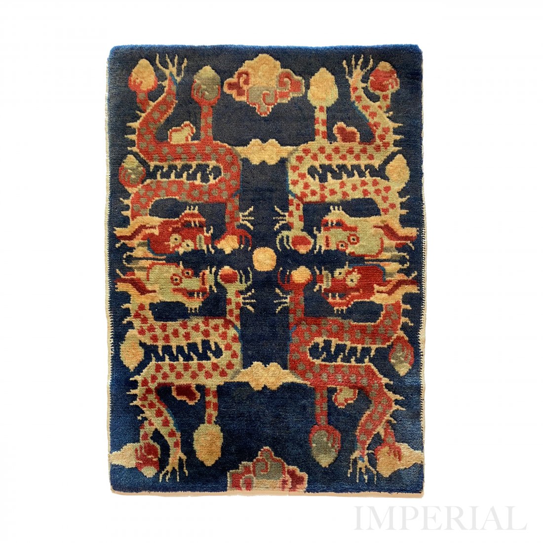 UNIQUE CHINESE RUG, 1910s: A Unique Chinese Rug, Gansu, Early 20th Century. Decorated with 4 Dragons on Indigo blue field. Natural dyes, 64cm x 67cm.