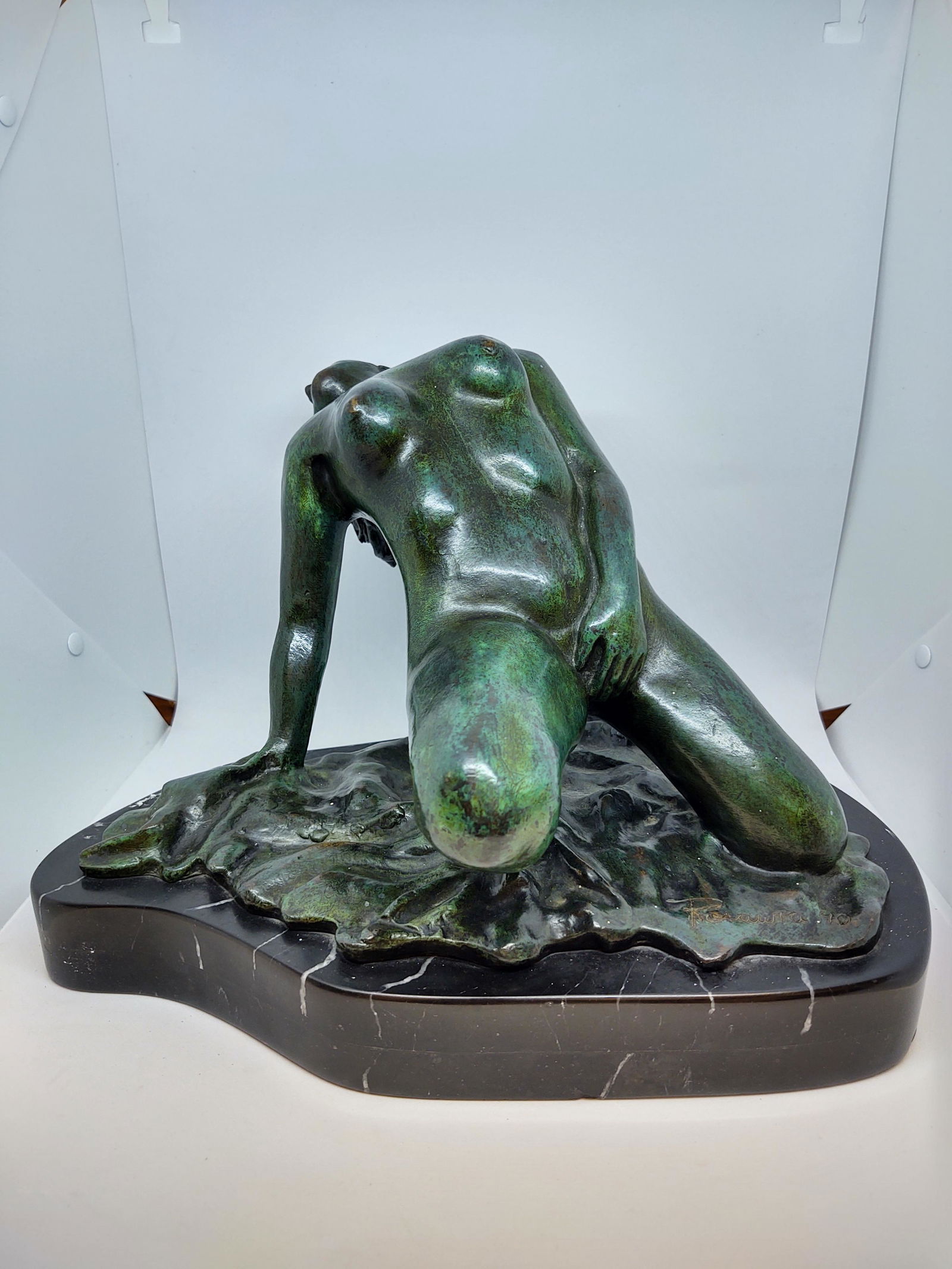 Nude in Bronze on Black Marble Base: Bronze Nude Statue finished in green patina on a black marble base. In excellent condition. Wear consistent with age and use. Dimensions: H 9.5" x W 13.7" x D 8.5".