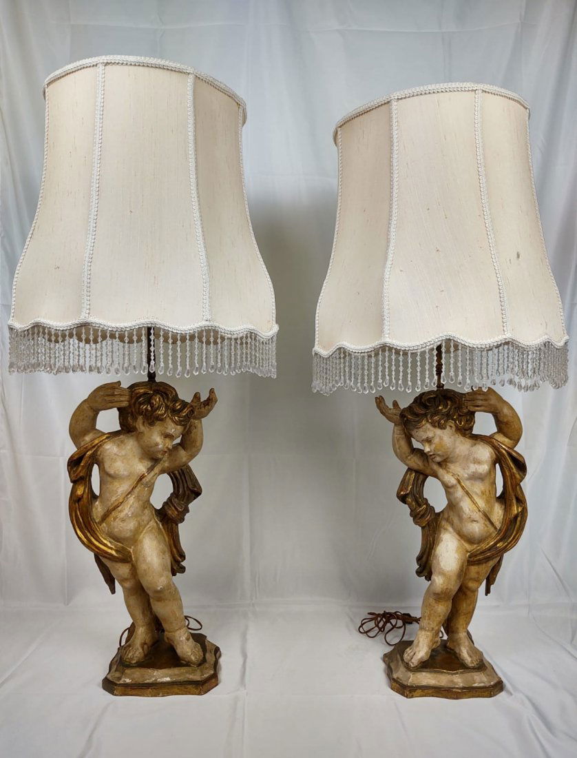 Antique Venetian Putti Table Lamps: Pair of antique Venetian putti table lamps with white shades. Dimensions: H 38" from the bottom of the lamp to the top of the lamp without the shade x W 10.5" x D 5". Measurements for the shade is: 18