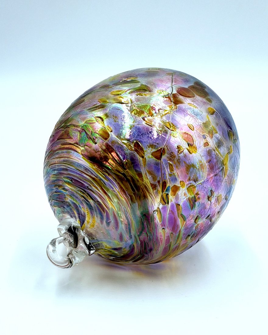 Hand Blown Art Glass Ornament: Richly colored hand-blown art glass oval ornament has a glass loop for adorning any space you choose. DIMENSIONS: 4.25 inches high and 3.25 inches wide.