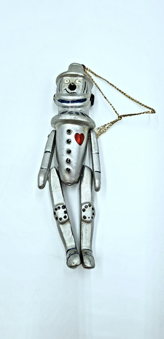 Vintage Enesco Wizard of Oz Tin Man Ornament: The charming Tin Man hanging ornament has moving arms and legs. By Enesco Designed Giftware. DIMENSIONS: 5.25" high, 1.25" wide, .75" deep. ORIGIN: Taiwan