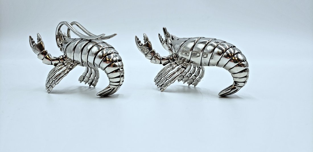 Lobster Salt and Pepper Shaker Set: Add fun and flair to a tablescape with this darling set of chrome salt and pepper crustaceans. DIMENSIONS: 4.5" wide, 2.5" high, 2" deep