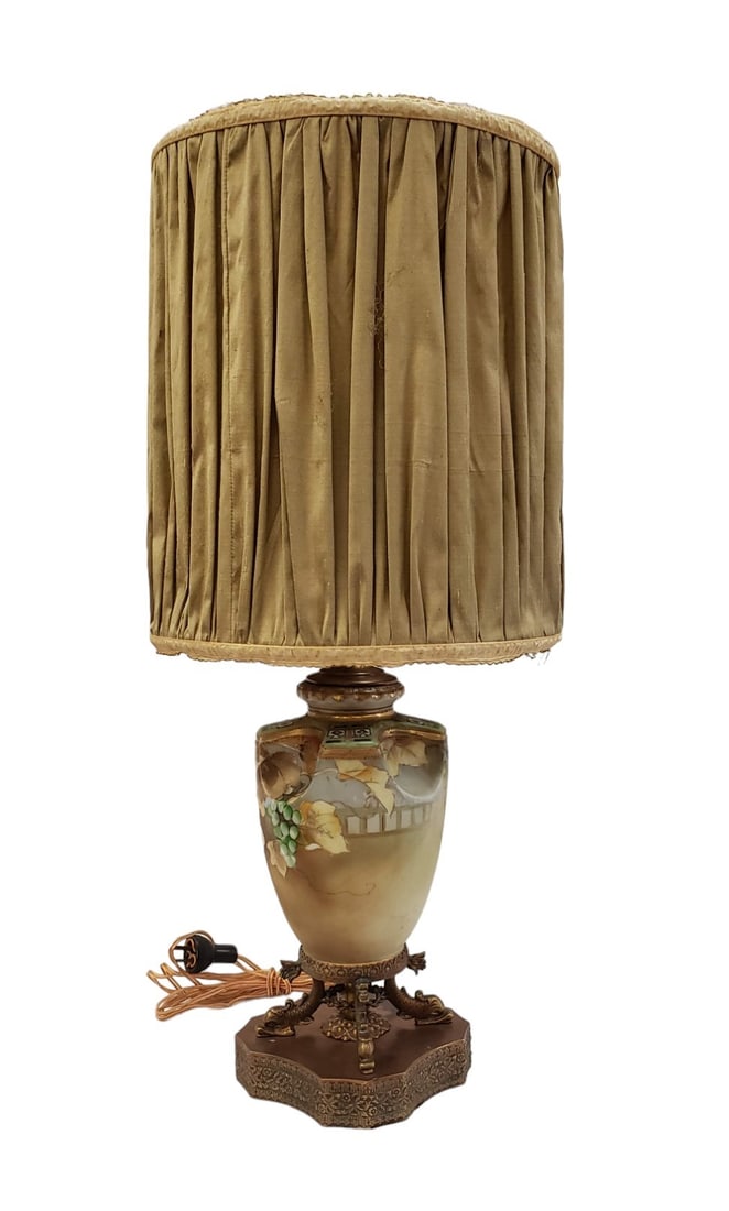 Antique Moriage Porcelain Table Lamp With Silk Shade: Moriage-style porcelain table lamp with silk shade. The lamp's body is delicately hand-painted with grapes and grape leaves accented by gold in the Moriage style technique. Four Japanese dolphins sit