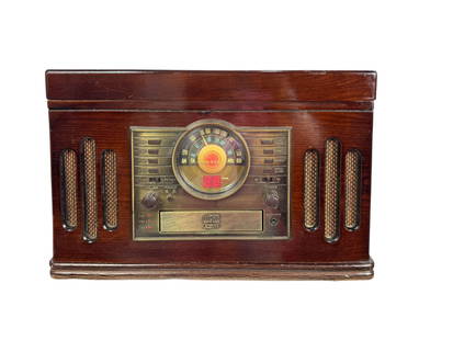 VINTAGE CROSLEY CR 73 4 IN 1 RADIO TURNTABLE RECORD PLAYER: The Crosley CR73 4-in-1 Radio Turntable Record Player is a vintage-style multimedia entertainment system housed in a classic wooden cabinet. It features a built-in AM/FM radio with a retro-style illum
