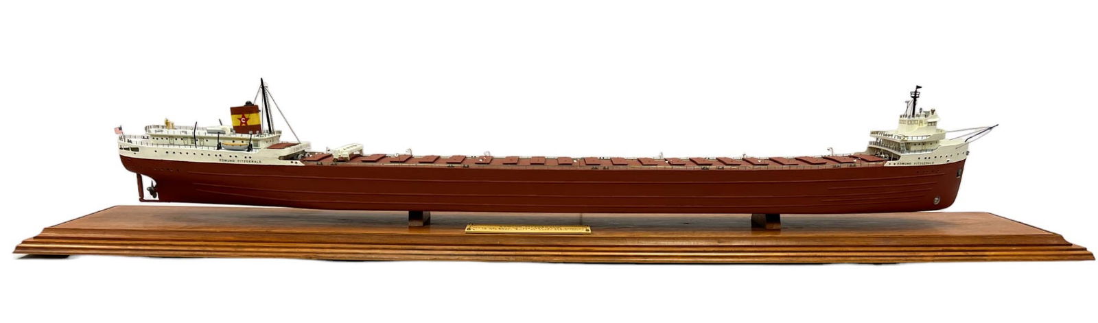 REPLICA OF THE GREAT LAKE FREIGHTER, EDMUND FITZGERALD IN PROTECTIVE CASE: A replica of the SS Edmund Fitzgerald, built by Harry Carle in 1992, is encased under Lucite. Launched in 1958, the SS Edmund Fitzgerald was the largest ship on the Great Lakes, known for setting carg