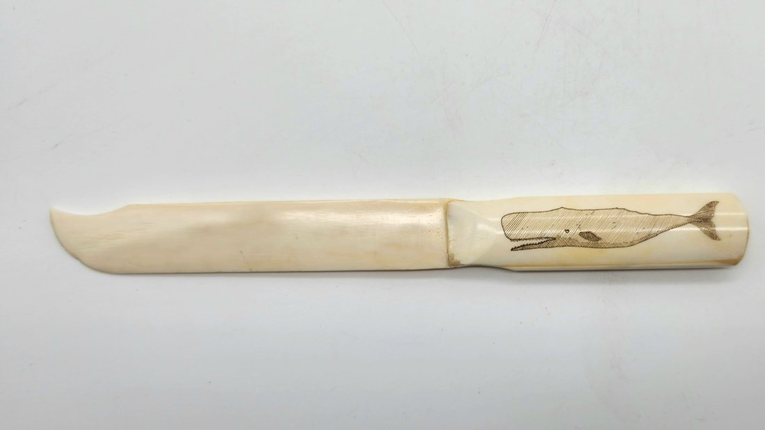 Inuit Carved Scrimshaw Letter Opener of Whale: Inuit Carved Scrimshaw Letter Opener of Whale. See photos for details as part of description. Excellent condition. Measures approximately 9.00 inches long x 1.00 inches wide x 0.48 inches high.