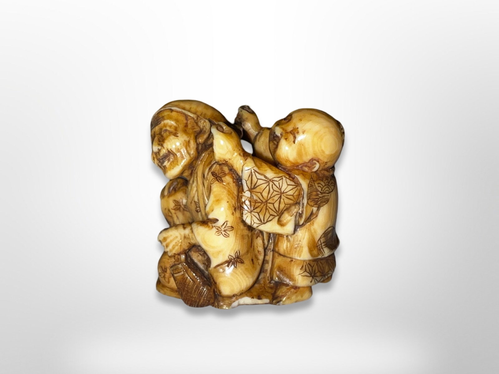 Signed Japanese Carved Netsuke Boy With Monk: Signed Japanese Carved Netsuke of Boy With Monk. Measures approximately 1.3 inches long by 1.2 inches high by 1 inch deep.