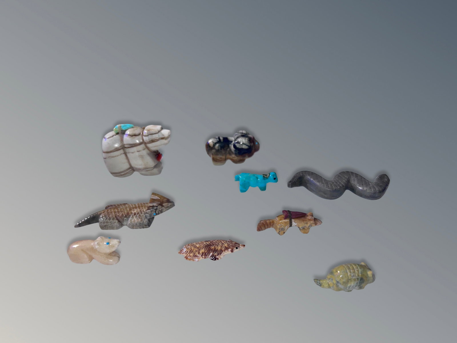 10 Native American Zuni Fetishes: 10 Native American Zuni fetishes, icluding ram by Navajo Amos Pino. Largest measures approximately 3.5 inches long.
