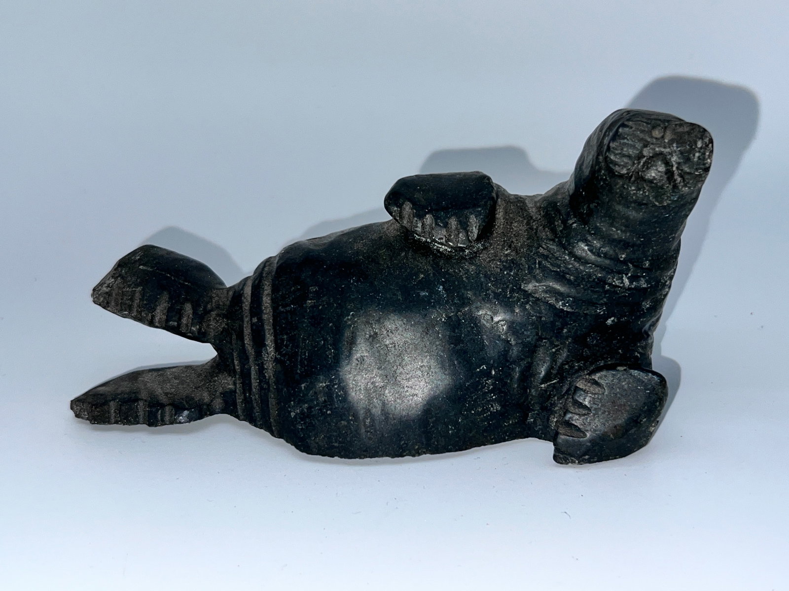 Inuit Sea Lion Carving by Luke Nakoolak: Inuit Sea Lion Carving by Luke Nakoolak. Measures approximately 6.3 inches long X 3 inches high X 3 inches deep.