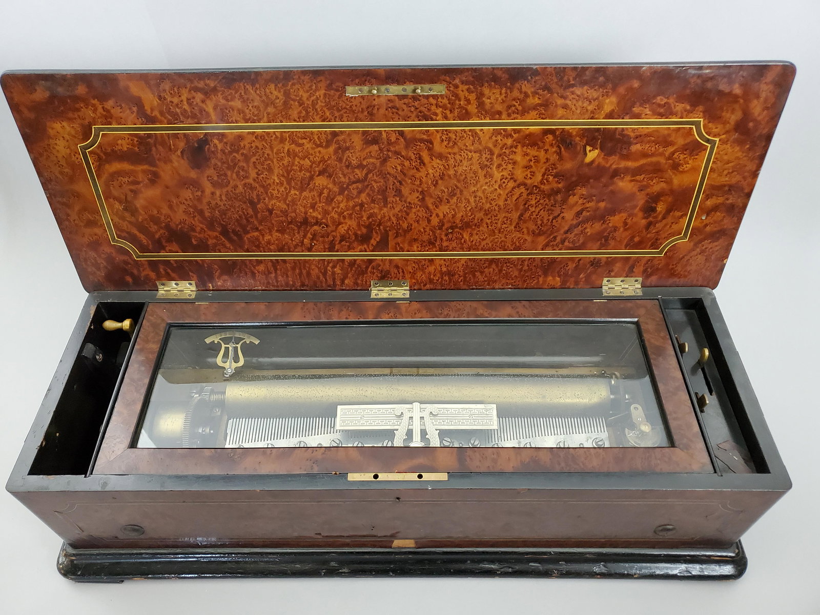 Antique 19th Century Swiss Cylinder Music Box: Has one cylinder, three toggles for stop, play and repeat. Crank wound. Hinged lid case of burlwood veneer and ebonized wood. Musical components in good standing, plays well with no major issues. Case