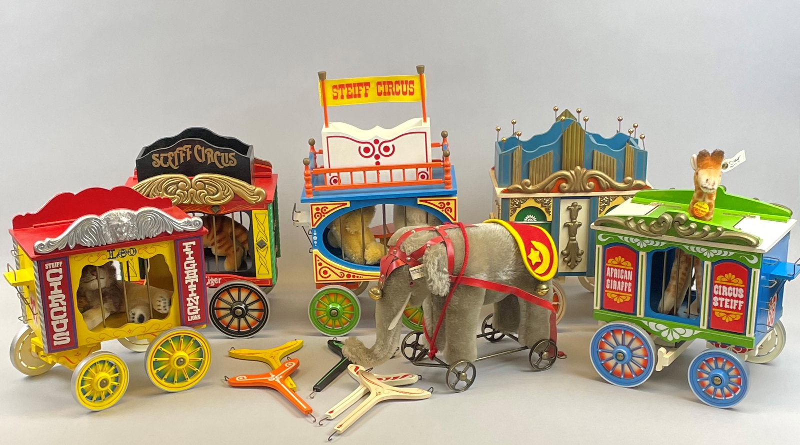 Retired Steiff Golden Age of the Circus 5 Piece Lot: Lot comprised of five individual pieces, including; elephant on wheels w/ circus wagon, wagon w/ two bears, wagon w/ Bengal tiger, wagon w/ giraffe, and wagon w/ lion 'Leo'. Manufactured by Steiff, Ge