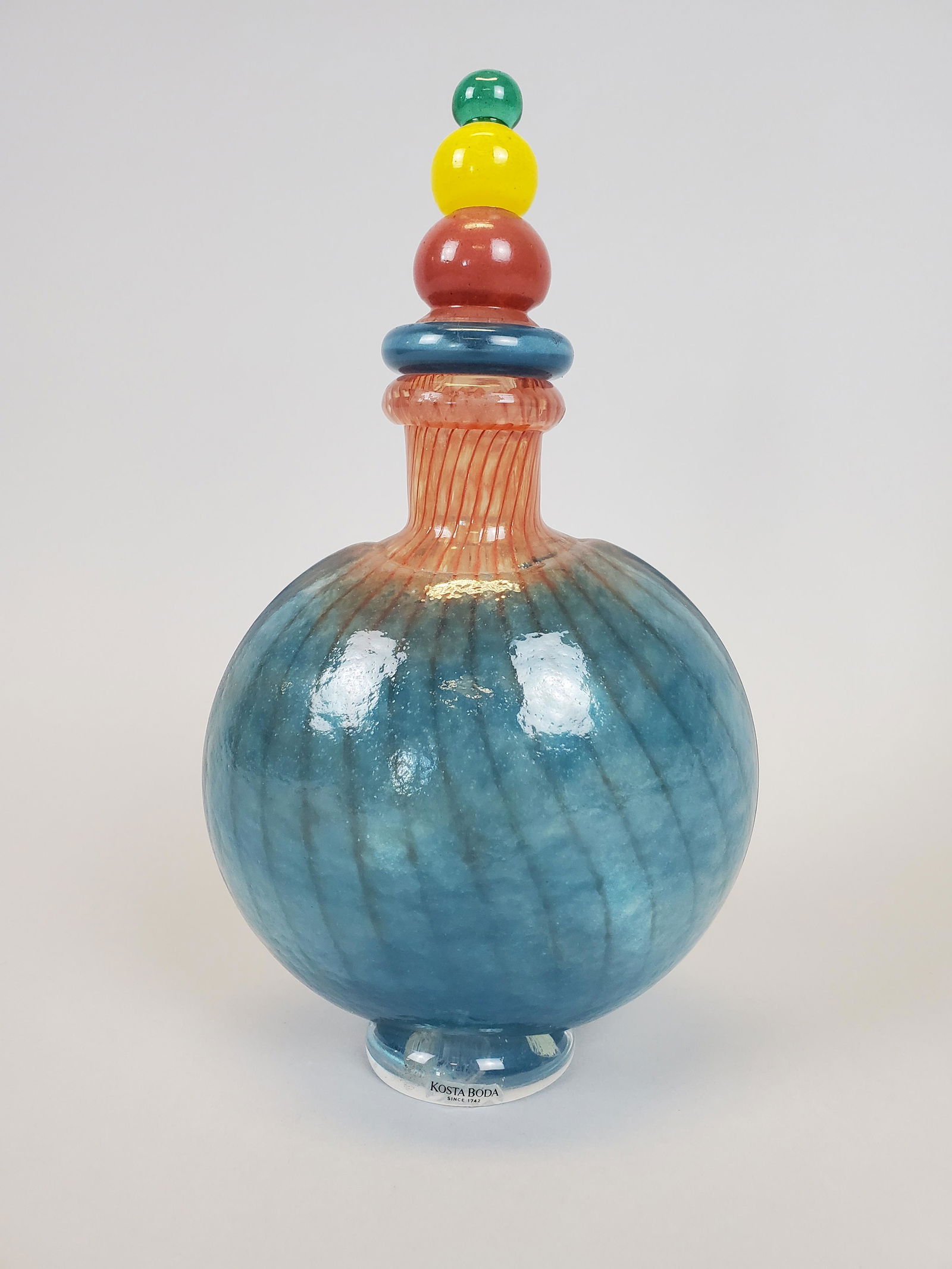 K. Engman for Kosta Boda Modernist Art Glass Decanter: Whimsical blown art glass decanter bottle with stopper, signed and numbered, also with original manufacturer's sticker. Kjell Enman for Kosta Boda, Sweden. Mild scuffing to bottom surface, otherwise e