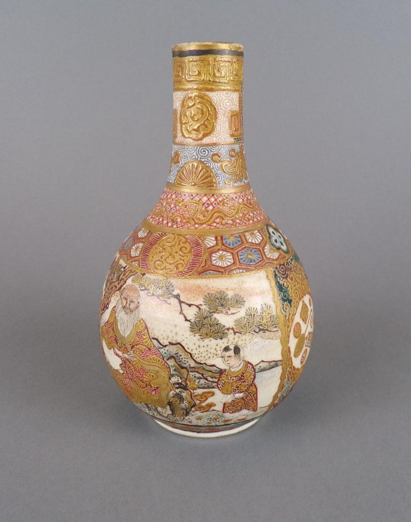 Antique 19th C Miniature Japanese Satsuma Vase: The bulbous earthenware form with slender neck, raised dimensional hand-painted polychrome details and gilding, features social scene with monk or scholar; bottom with maker's imprint, Meiji period. C