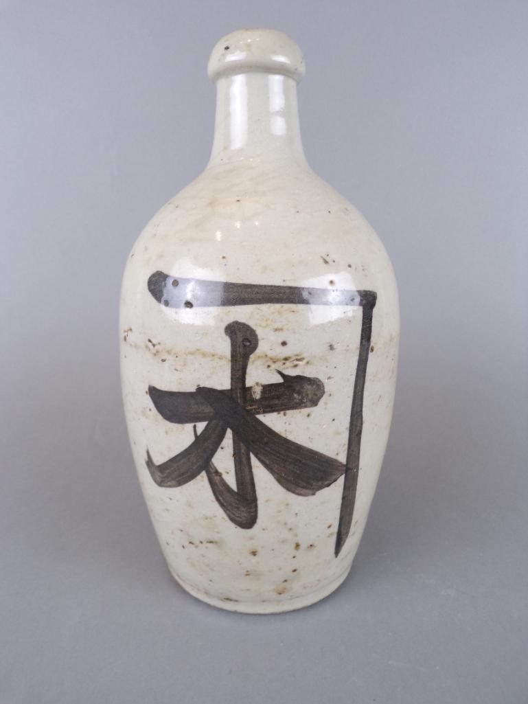 Antique Signed Japanese Meiji Tokkuri Sake Jug: Glazed stoneware binbou-tokkuri jug with Kanji characters, including artist's signature, circa 1890. Shows mild age related wear, general crazing to glaze and natural imperfections associated with pro
