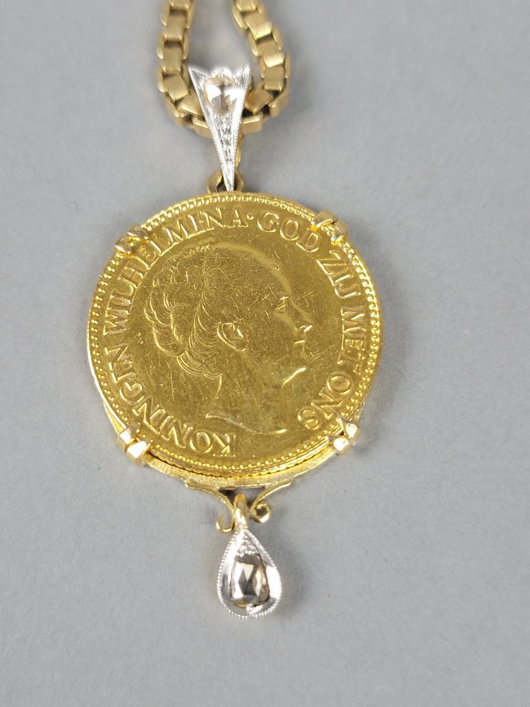 1933 Dutch Guilder Gold Coin Pendant Necklace: The 10 gulden Wilhelmina I coin mounted in a frame (8.0 g), frame with small drop set with a rose cut diamond, bail also set with a rose cut diamond, with 23" box chain in 14 karat yellow gold (12.0 g