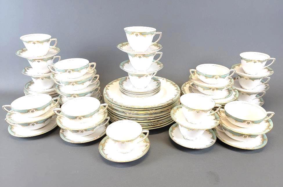 Royal Worcester Devonshire Bone China Tableware Set: The fine bone china table set (84 pieces total); Devonshire pattern for Royal Worcester (England, 1962) in smooth snow white with edges in ice green and gold gilt, featuring settings for twelve with 1
