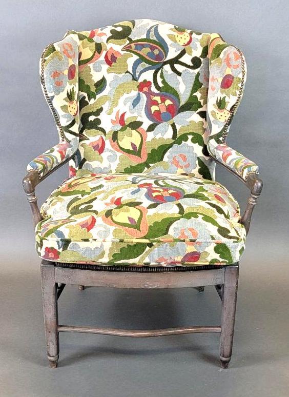 Antique French Country Wingback Armchair w/ Jacobean Upholstery: Antique 19th century French armchair in solid wood with a dark distressed or 'weathered' finish and woven rush seat, enveloped back rest / down seat cover / padded armrests upholstered in a st
