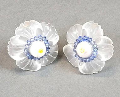 Pair Russell Trusso Flower Earrings, Crystal, Sapphire, Pearl, 14K: Russell Trusso, Cleveland School, a pair of flower form earrings; the petals cast in hand carved satin rock crystal, each center set with a bisected 8mm round freshwater pearl studded with a diminutiv