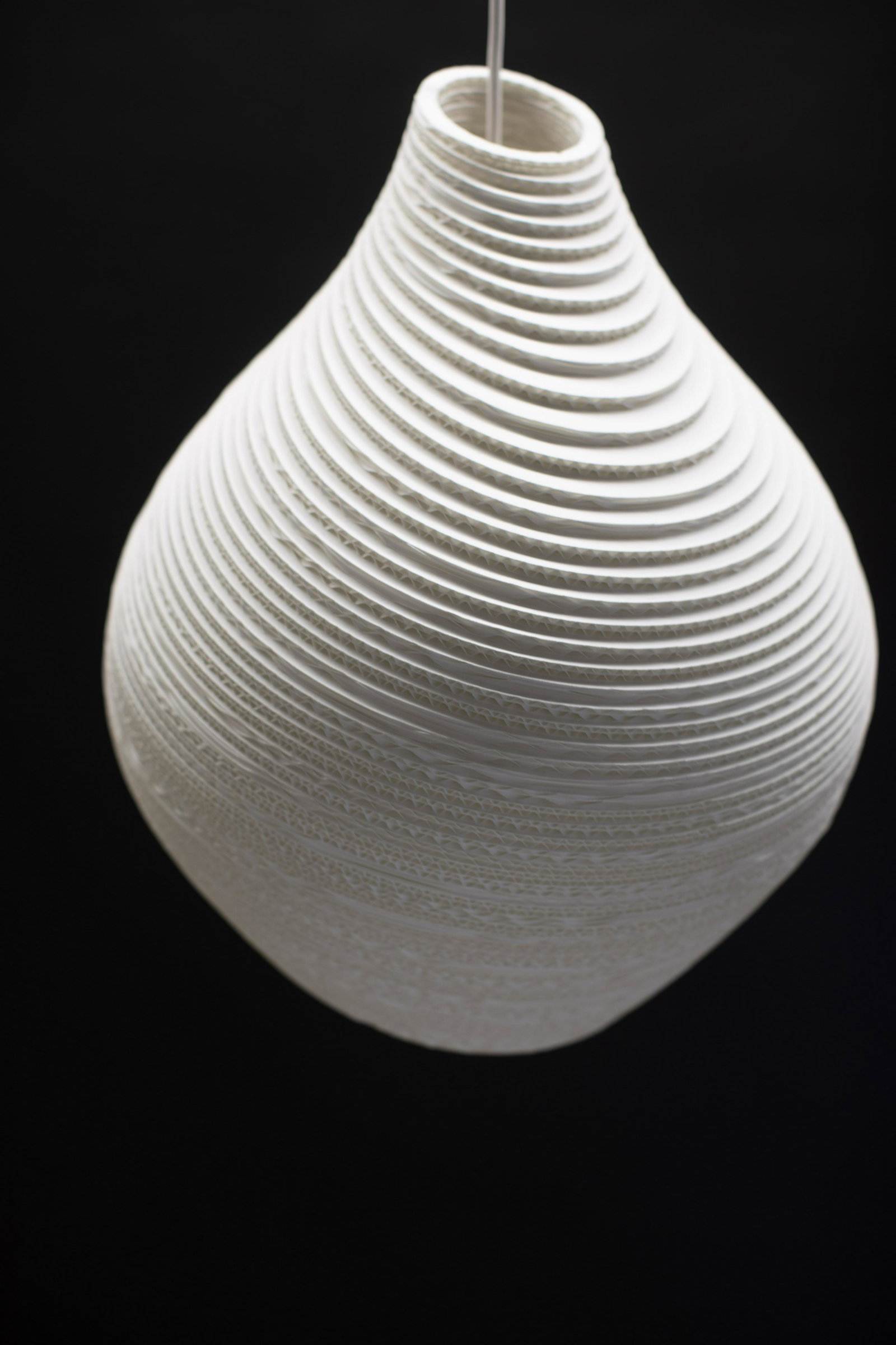 Medium Hive Scraplight Pendant in White, By Greypants: The Hive Scraplight Pendant offers an organically shaped design that is handmade from re-purposed cardboard boxes and features a non-toxic fire retardant treatment. THis is the medium size pendant whi