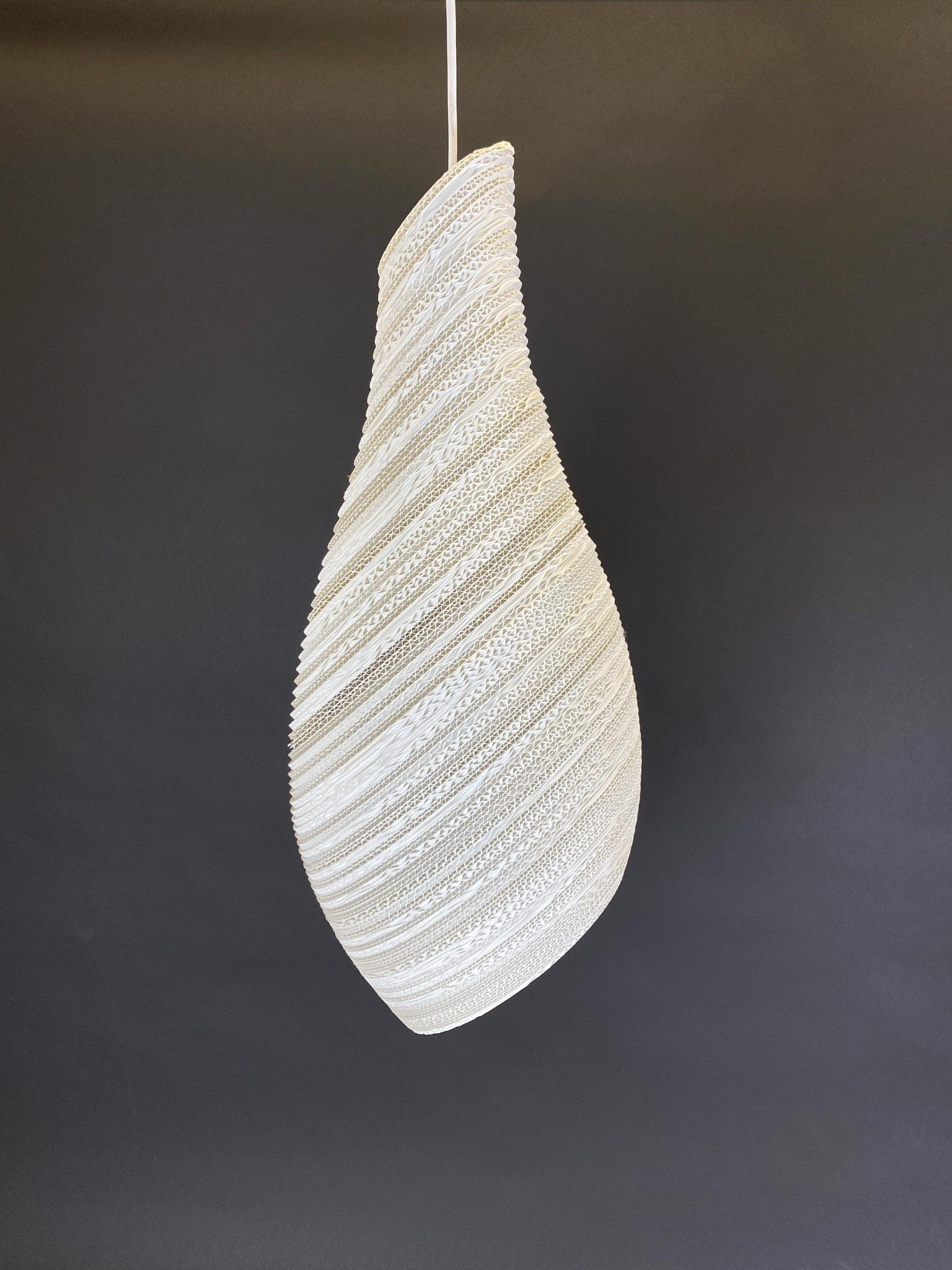 Greypants Nest Scraplight Pendant in Medium: The laser-cut lines and hand assembly of the Nest Pendant from Greypants present a study in functional aesthetics combined with a softer, living shape. A shade of layered, recycled cardboard provides 