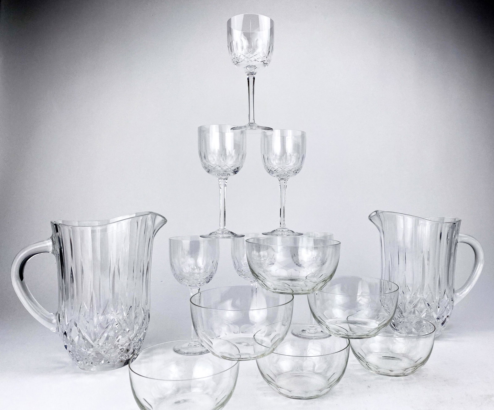 Assortment Crystal Tableware: Beautiful cut crystal stemware six wine glasses, six cut crystal bowls, two cut crystal pitchers.