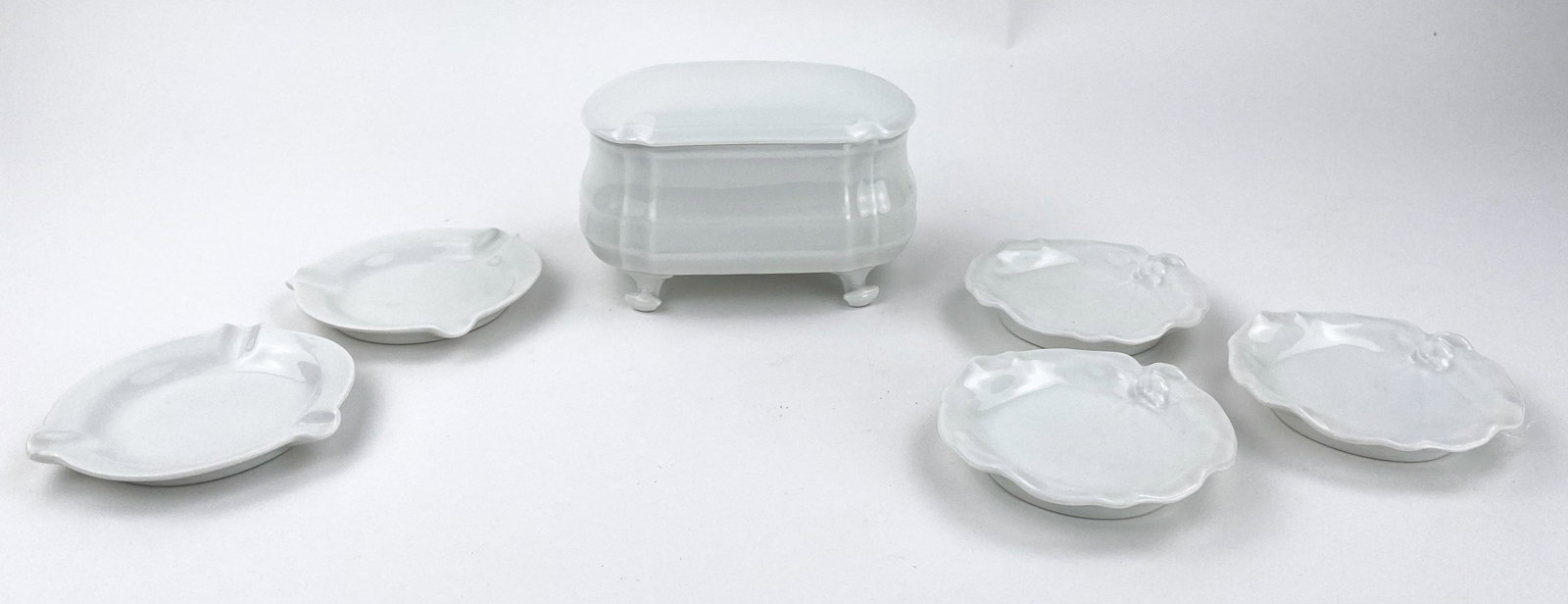 Limoges France Cigarette Holder and Ashtrays: Porcelain Limoges delicate white lidded cigarette box and 5 white ashtrays. Stamped Limoges on bottom of all. 3 ash trays are 3 3/4" Diameter. 2 are 4" Diameter. the cigarette boc measures 5 3/8" L x 