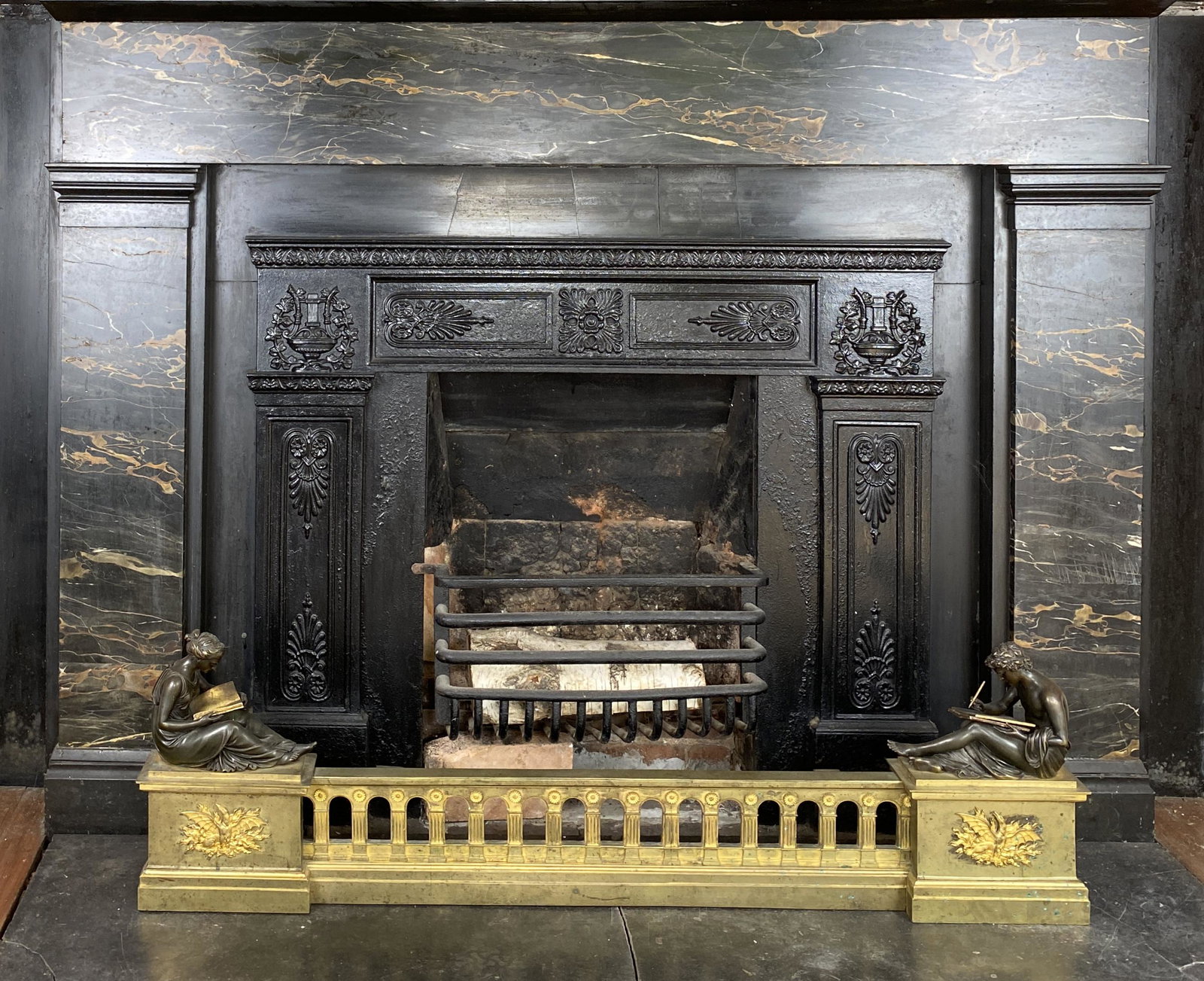 Antique Empire Ormolu Fireplace Fender: Antique Empire syle Ormolu mantel bar. Brass and Bronze cast figures depicting Study and Philosophy. Male is writing, female is reading.Possibly Designed by Boizot, and Possibly originate from the wor
