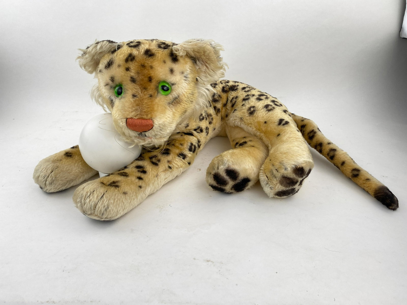 Laying Leopard and Seated Baby Leopard: Vintage Steiff leopard with amber eyes and floss nose. Vintage 1950's Steiff large lying leopard with glass eyes covered with mohair. 27" long