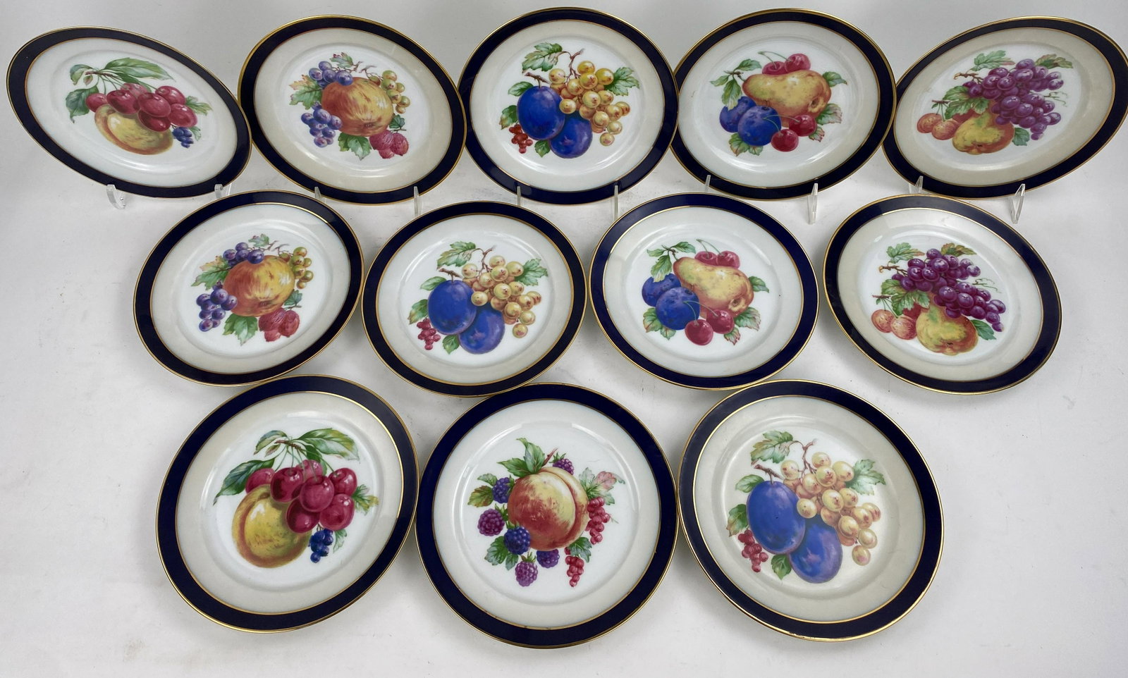12 Antique Bavarian Salad/Dessert Plates: Beautiful 8" antique Bavarian dessert or salad plate with gold trim. Featuring an assortment of fruits. Stored well in good condition.