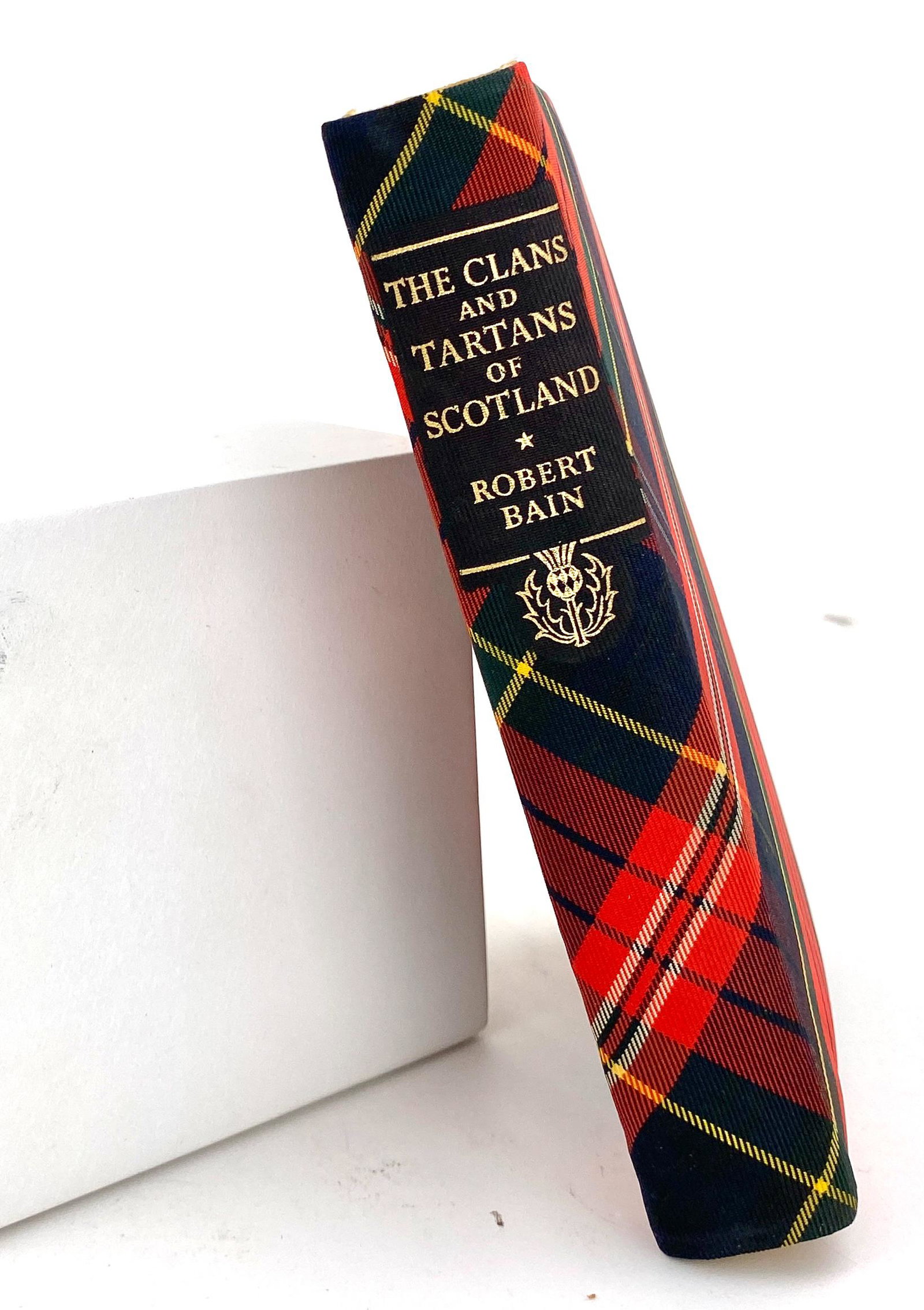 The Clans and Tartans of Scotland Hardcover Book: Beautiful padded silk tartan hardcover book. Pages are gilt edged. Well illustrated with color illustrations of tartans along with the history of tartans. 1950