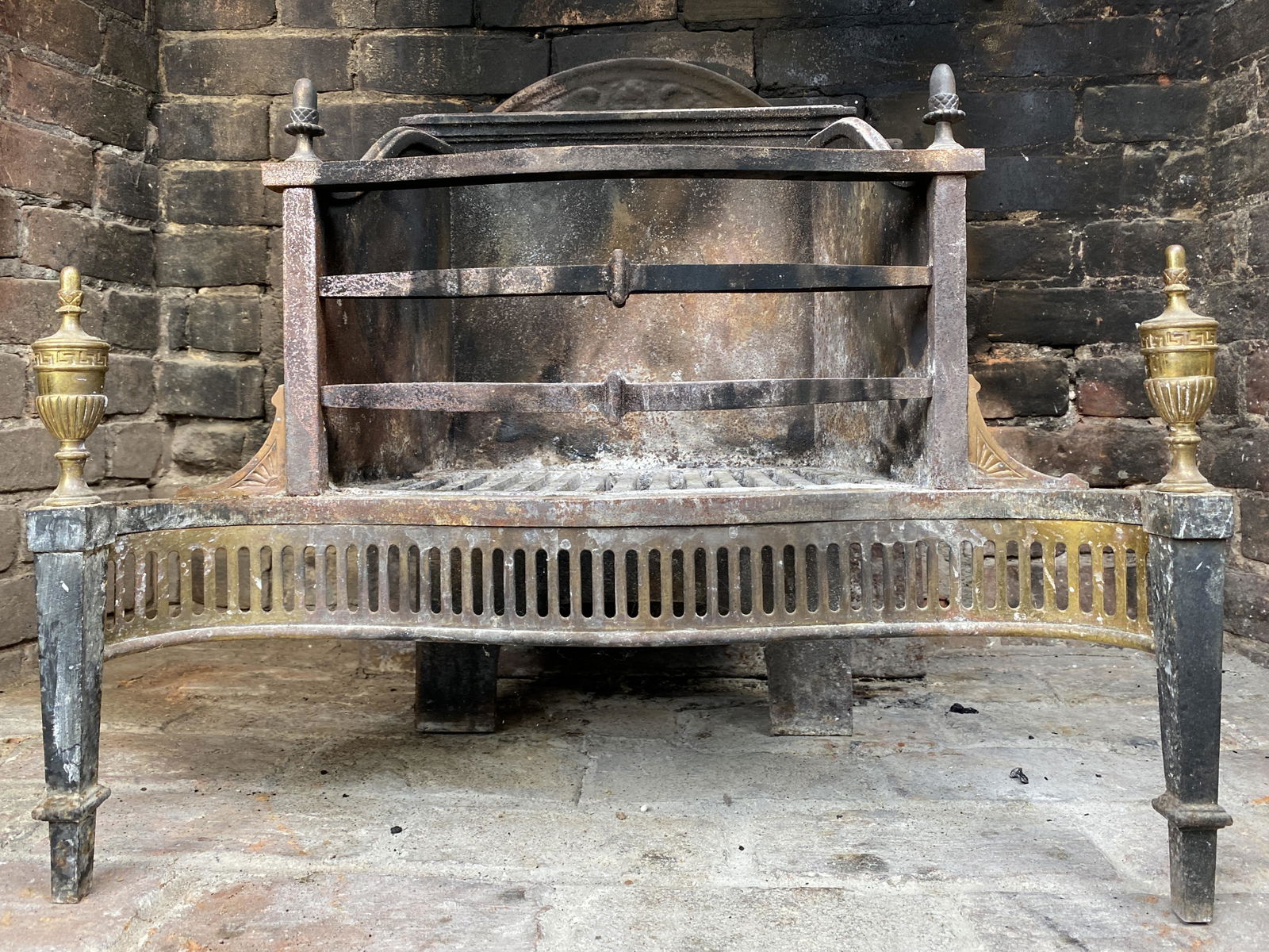 Wm. H. Jackson Antique George III Style Fireplace Cradle: Antique George III style, brass, cast iron grate fireplace cradle or log holder. Two front legs with brass finial detail. Heavy and Beautiful. 24" W x 13" D x 19 1/2" H