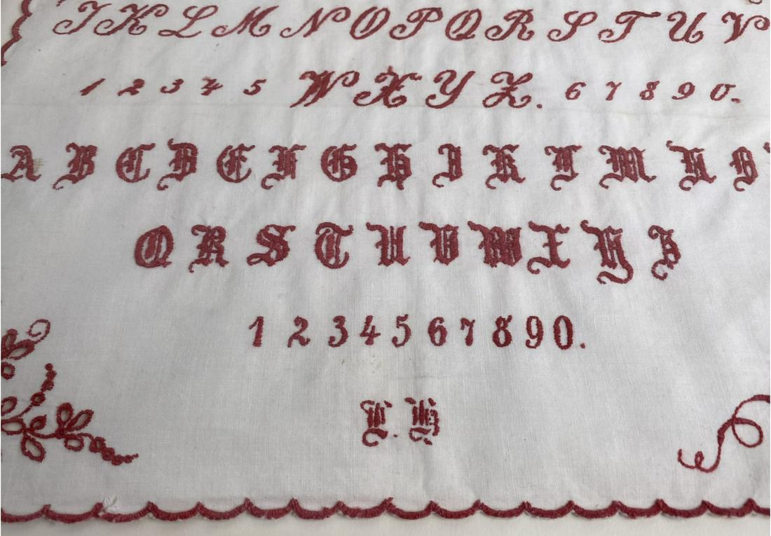 Antique Needlepoint Embroidery Sampler: White cotton background with red thread, the calloped edge has patterns on each corenr, a crown at top and the initial of the maker at bottom center.Cloth measures 12 x 10 3/4" H. Frame measures 14 1/