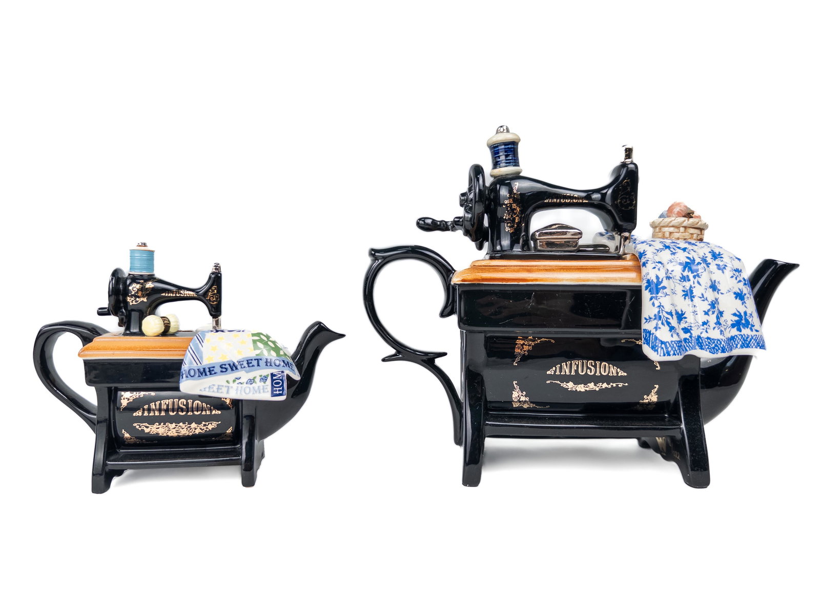 Two Paul Cardew Infusion Sewing Machine Teapots: PAIR OF PAUL CARDEW INFUSION SEWING MACHINES Ceramic teapots made in the shape of sewing machines. Dimensions (large) Width: Depth: Height: Dimensions (small) Width: Depth: Height: