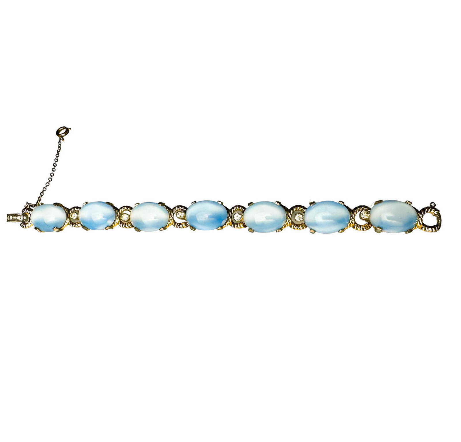 1950's Jomaz Blue Opalescent Blue Glass and Rhinestone Bracelet in Gold Setting: Phenomenal Mid Century Costume Jewelry specimen by Jomaz. All Rhinestones in tact, blue opalescent oval glass stones in four prong settings rhinestone accents on clasp and between each oval stone. Mea